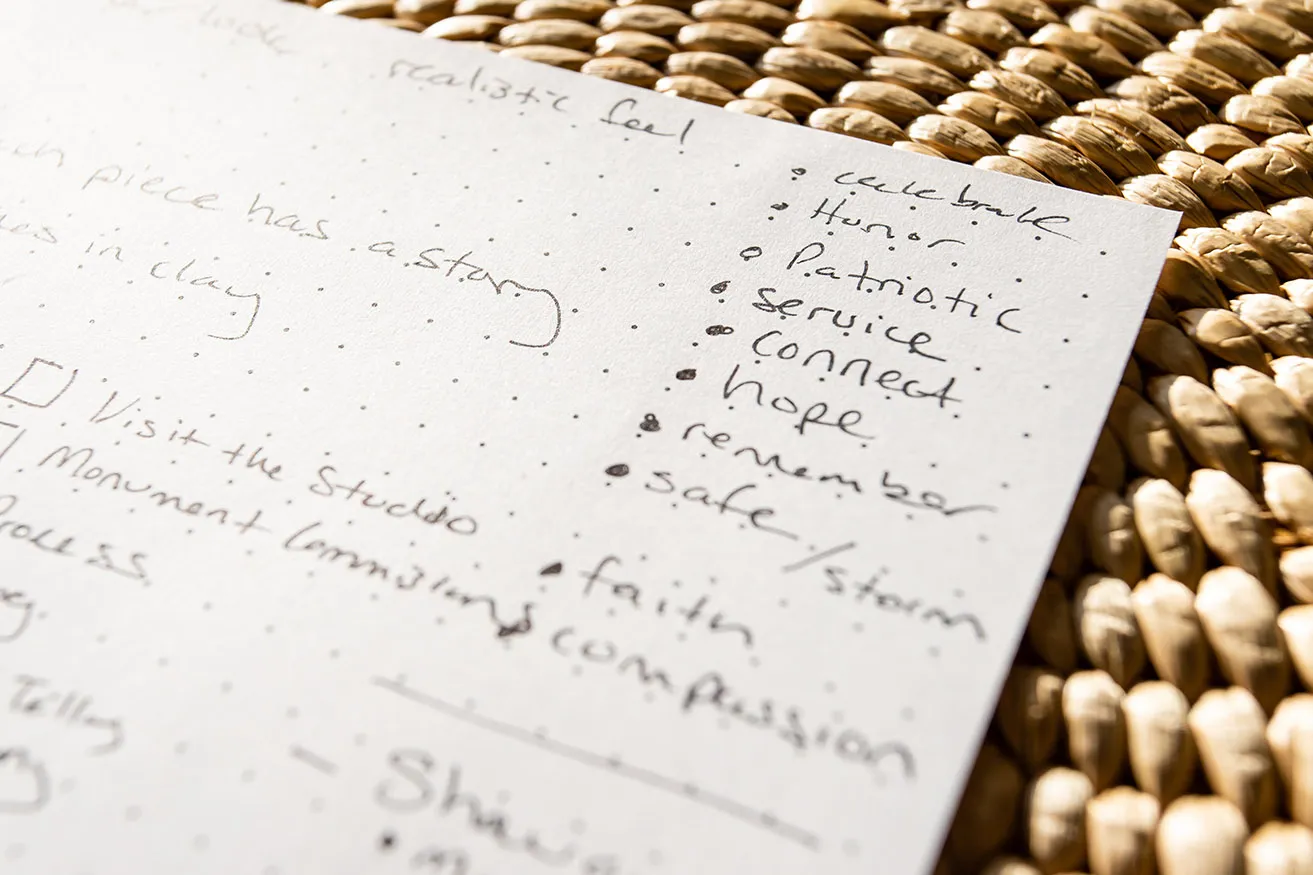 Amy's written notes for Scott Stearman's web design.  A bulleted list reads, "Celebrate, honor, patriotic, service, connect, hope, remember, safe/storm, faith, compassion." 