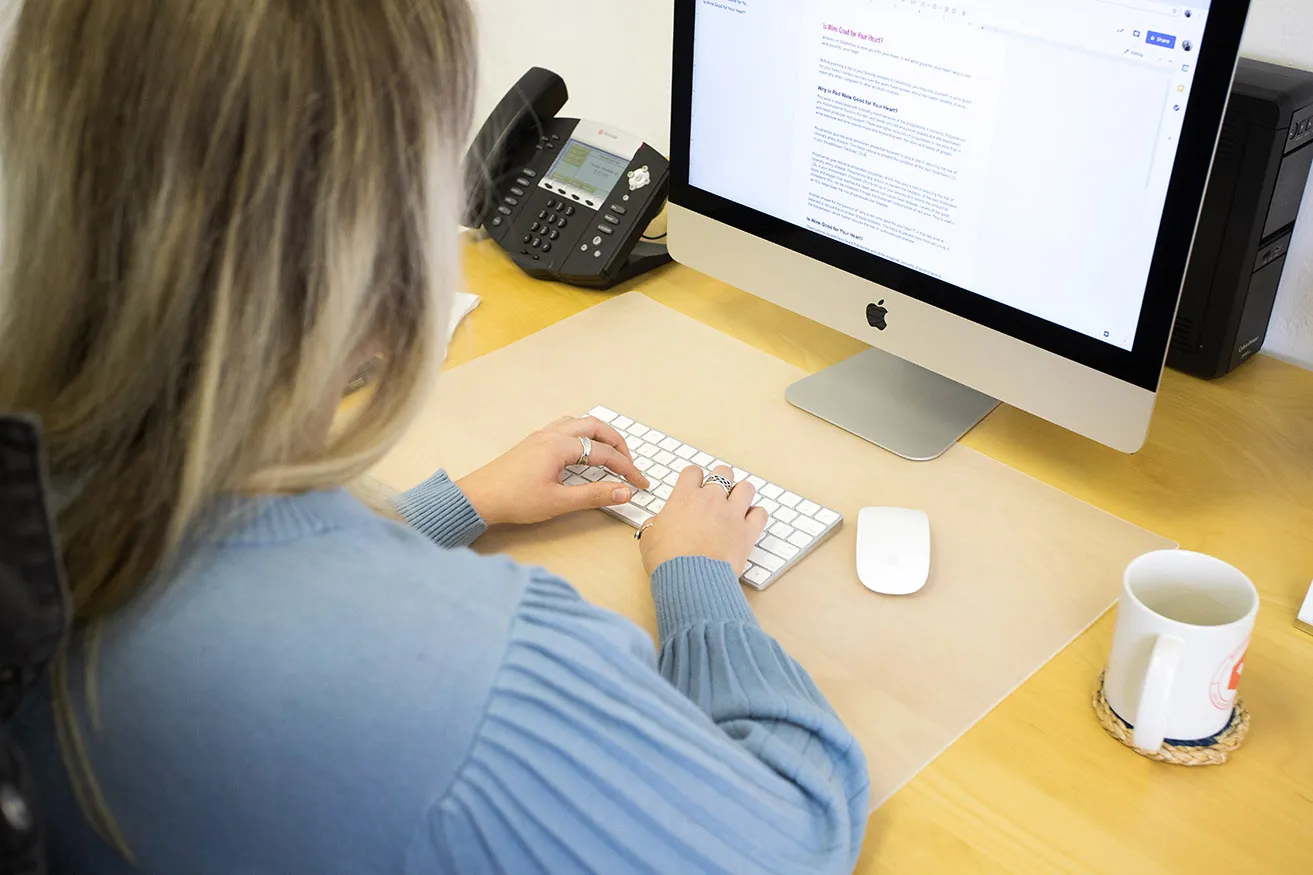 Kristen, the Project Coordinator, types original content for a client's search engine marketing Oklahoma campaign. 