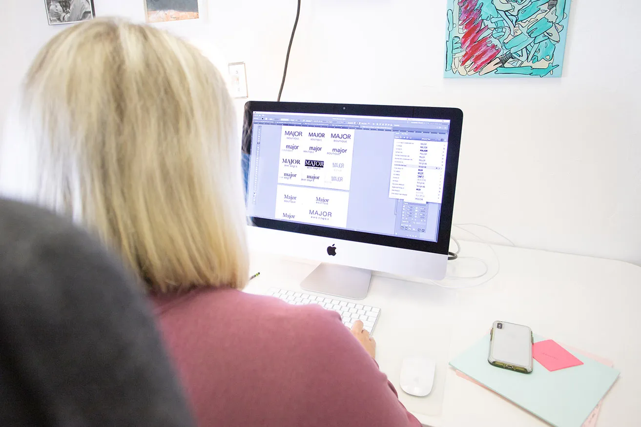 Amy, the Creative Director, compares different typography styles for Major Boutique's logo and web design in Dallas. 
