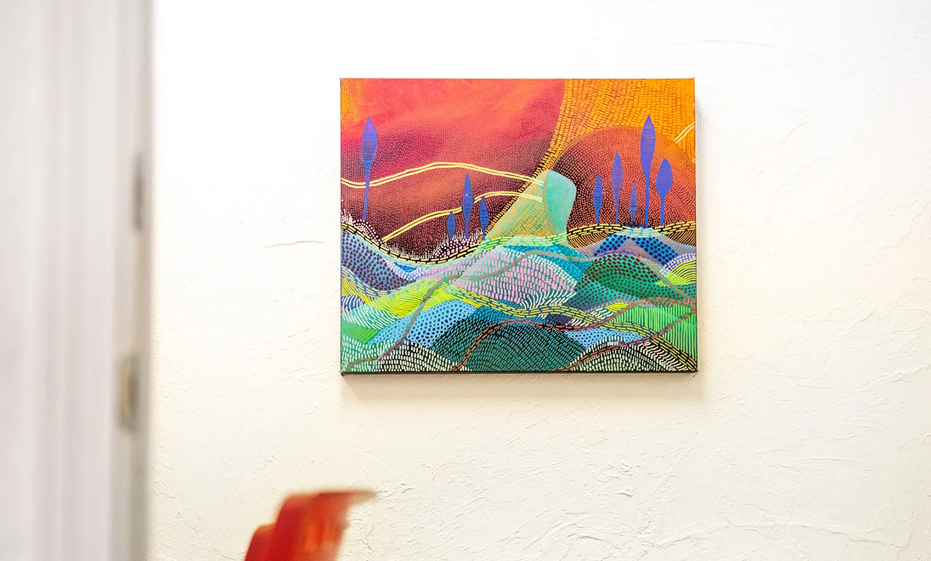 Environment, Time, and Emotion - myheartcreative A colorful, abstract landscape painting by Faye Miller hanging on a studio wall.