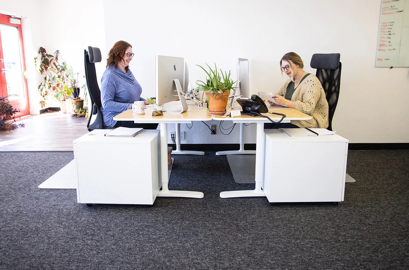 Kristen and April working on client content content at their desks in the myheartcreative studio. 