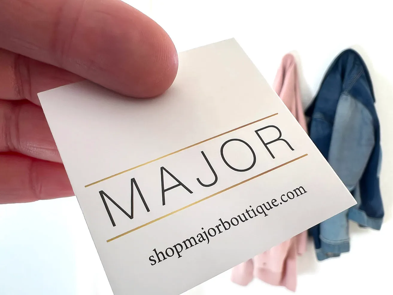 How Important is a Logo Design OKC to Your Brand? - myheartcreative Clothing tags with the Major logo printed on them to match their company branding OKC.