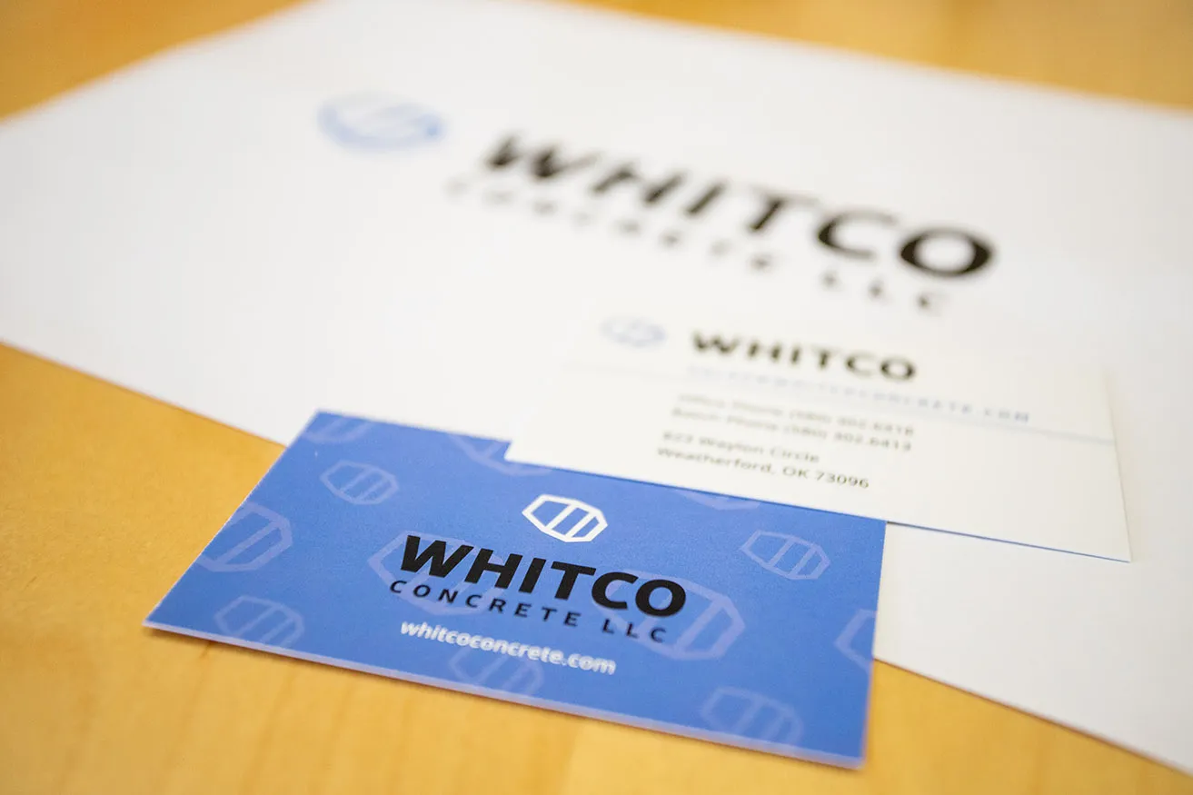 The business card for Whitco Concrete LLC, with the logo icon repeated on the background. 