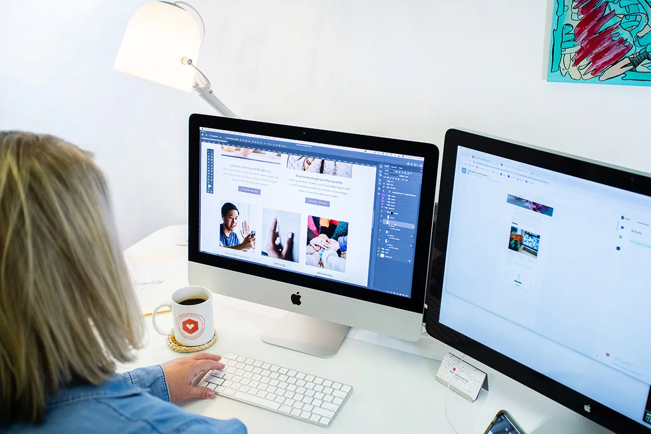 A web designer resizing photos for a client's website design. 