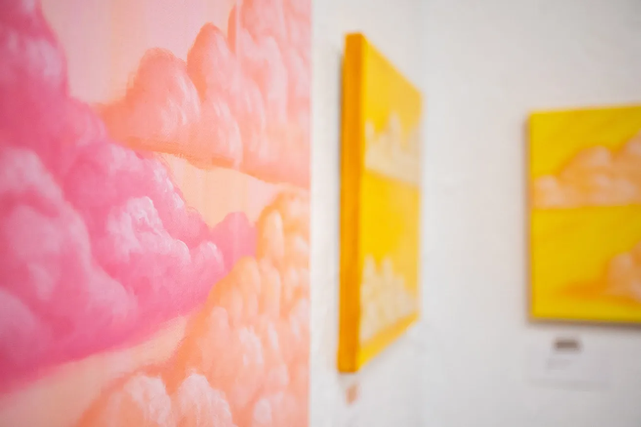 A close-up of a painting with pink clouds as created by artist Reshon Shirley. 