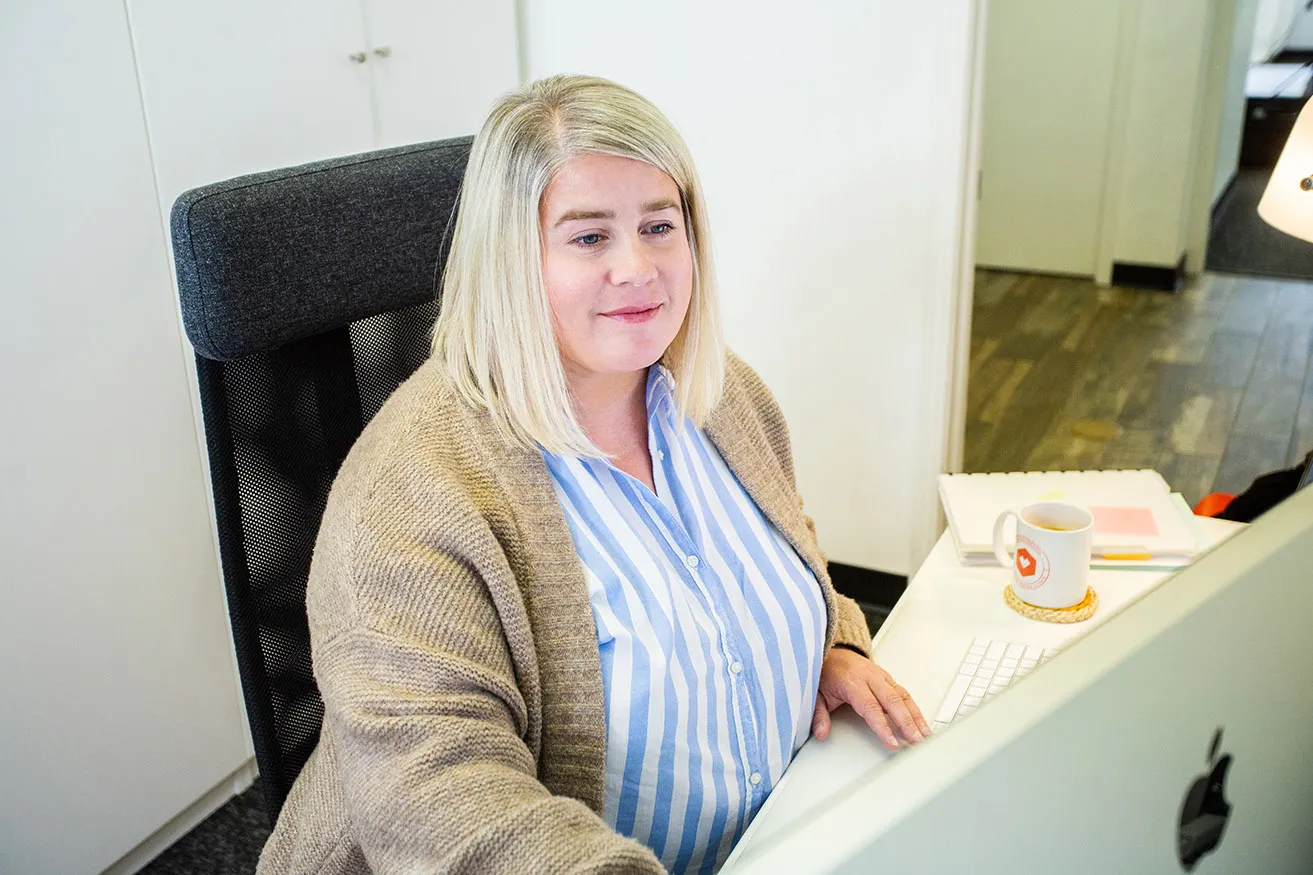 Amy, the Creative Director at myheartcreative, working on SEO Marketing Dallas projects at her desk. 