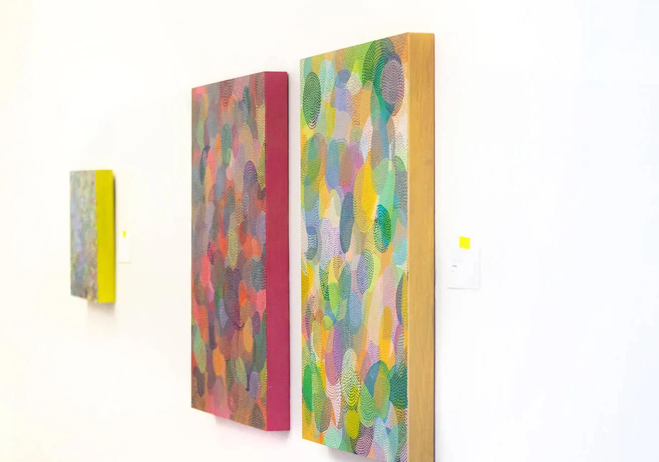 Find Artistic Inspiration. - myheartcreative Three colorful abstract paintings created by Sara Cowan that hang on the studio wall.