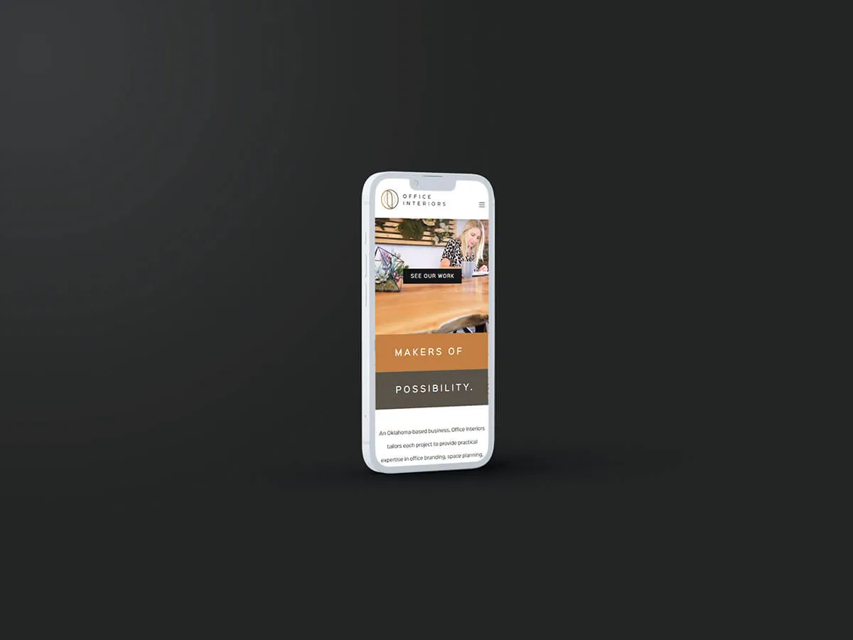 The responsive website design for Office Interiors shown on a smartphone. 