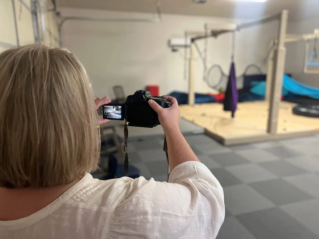 An Oklahoma photography professional from myheartcreative taking a photo of an indoor play area on a camera. 