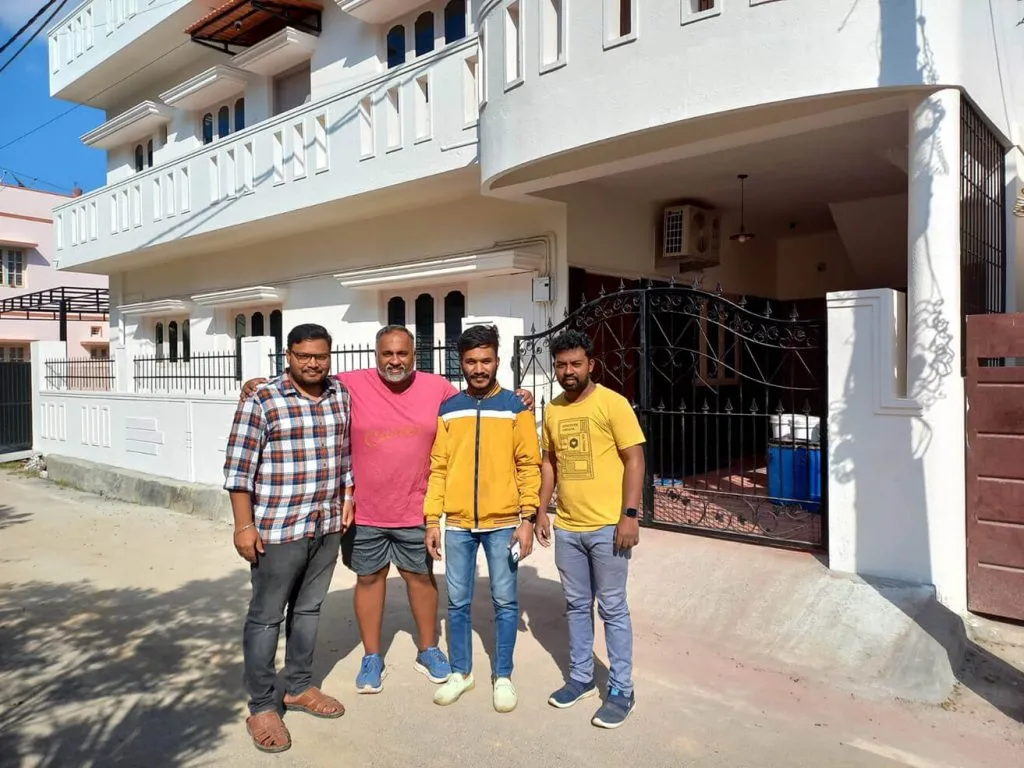Sam smiles with three members of the myheartcreative boutique web design team in front of the studio. 