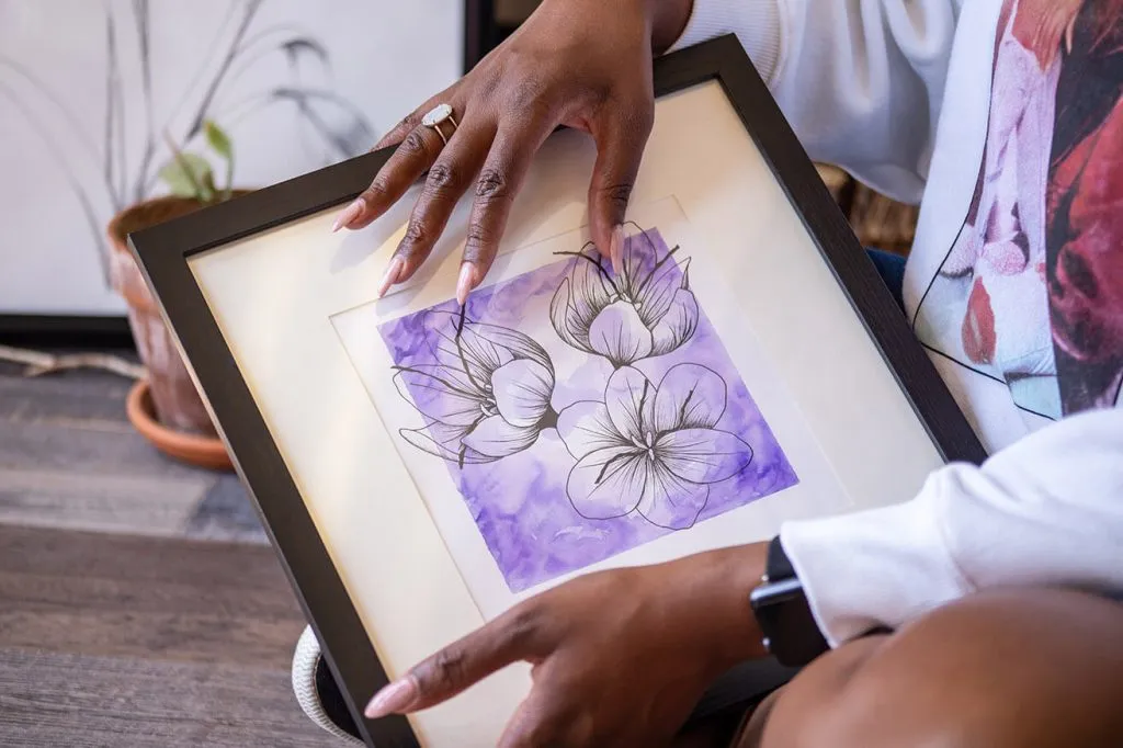 A floral artwork held by Oklahoma Artist Reshon Shirley.