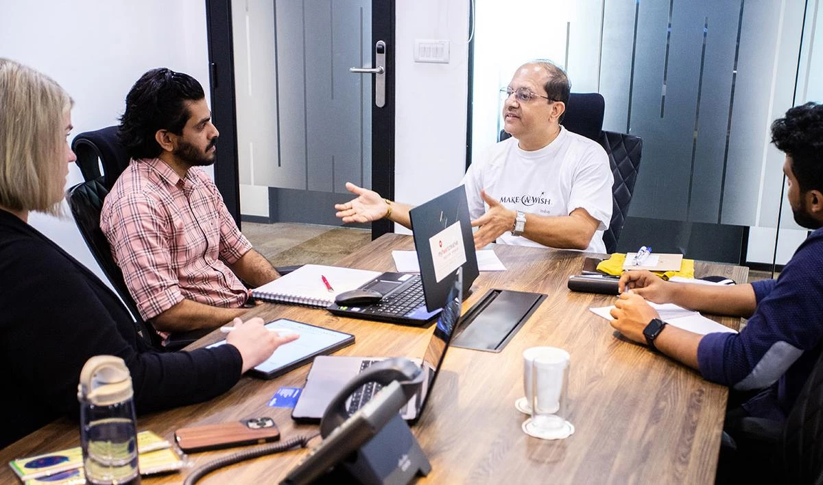 The myheartcreative team having a discovery meeting with an employee from Make-A-Wish India. 