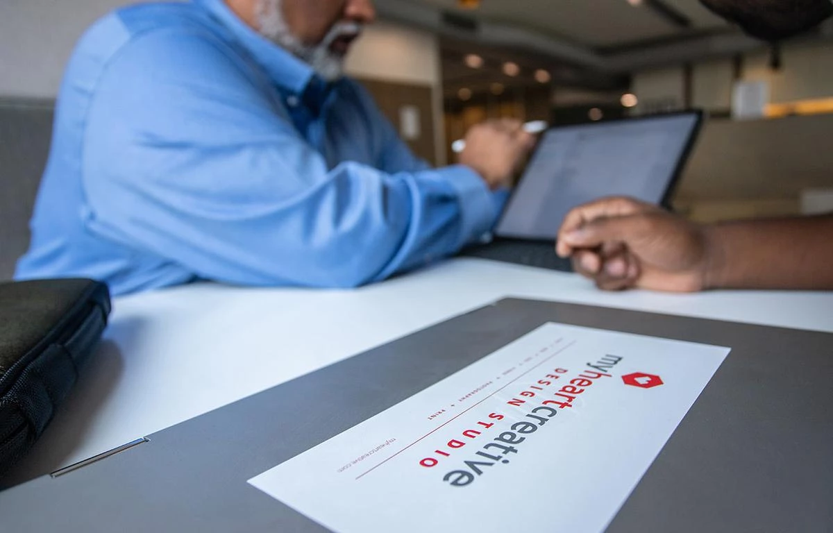An SEO Specialist and the Operations Director review an OKC Web Design for SEO strategies. 