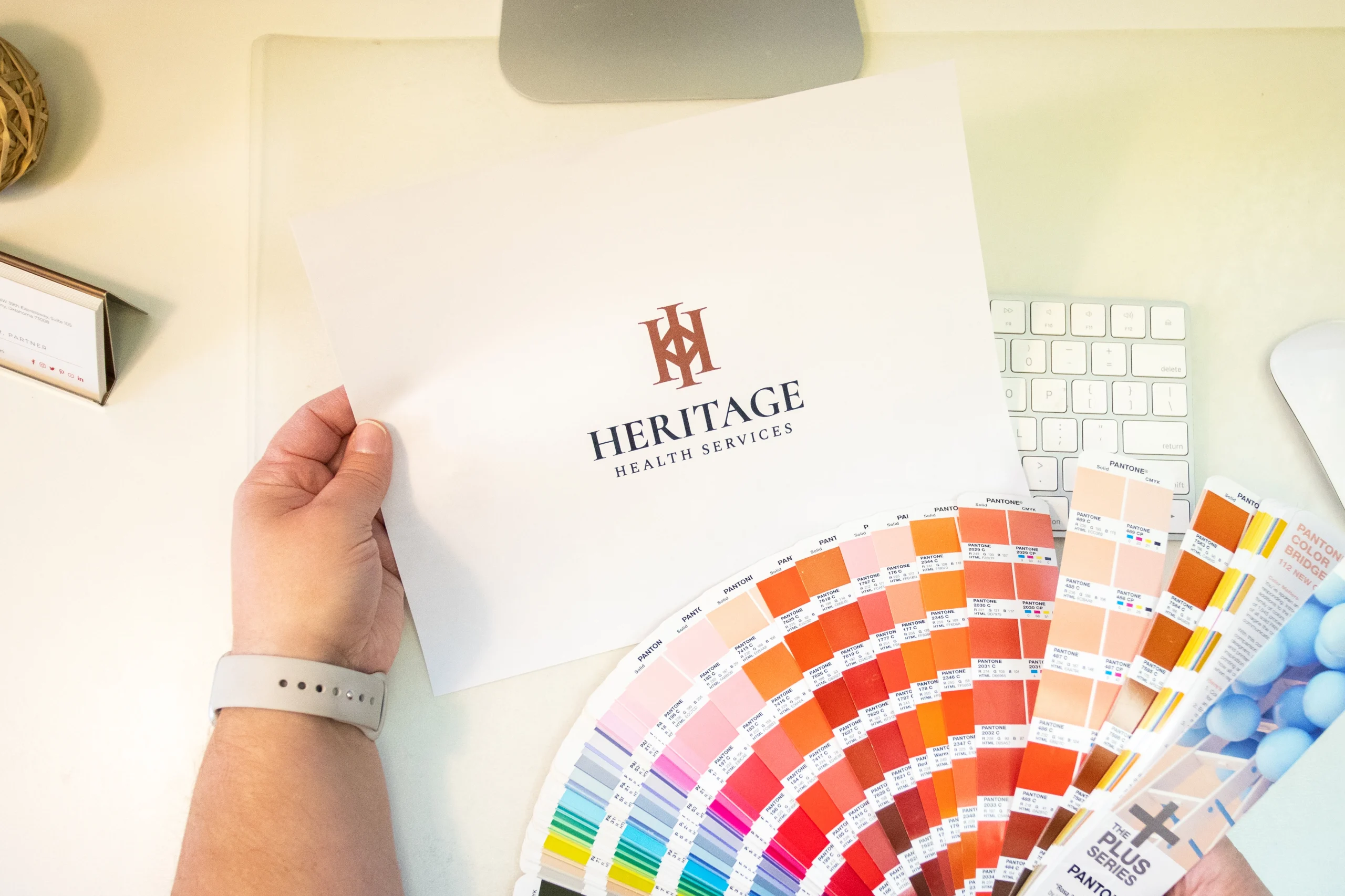 Understanding the Logo Design OKC Process - myheartcreative The Creative Director choosing among Pantone color chips for the Heritage Health Services logo.