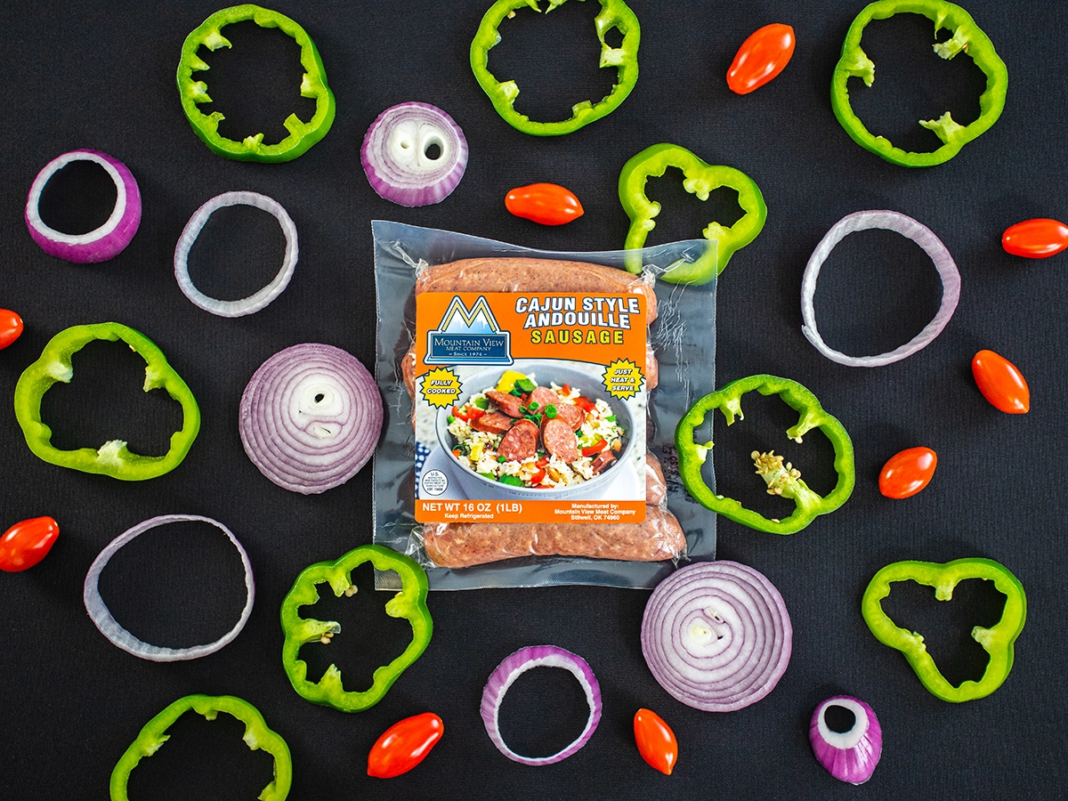 When to Use Dallas Commercial Photography vs. Stock - myheartcreative A professional product image of Cajun Style Andouille Sausage from Mountain View Meat Company with sliced onions and bell peppers surrounding the package.