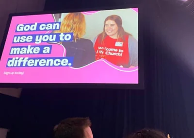 Amy on the big screen greeting others at Life.Church. God can use you to make a difference.