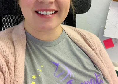 Creative Director, Amy, wearing a t-shirt from The Mack Impact.