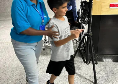 A young boy is escorted by a young woman from Make-A-Wish India.