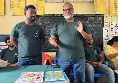 Operations Director, Sam, and Project Coordinator, Nathan, speak to young kids at a village school in India.