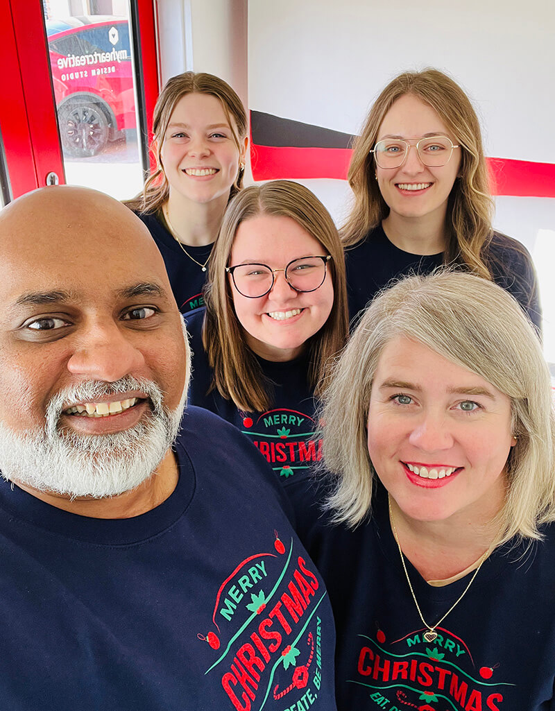 The myheartcreative HQ team wearing matching Christmas sweaters. 