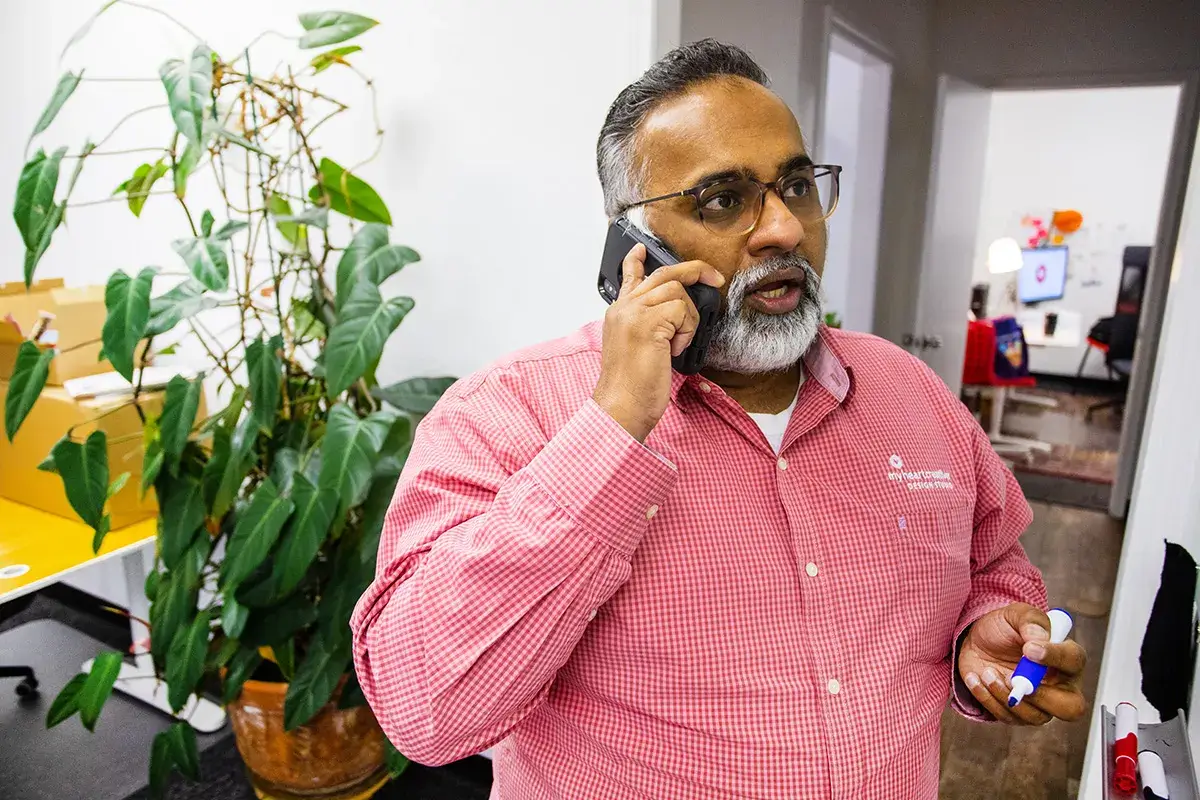 Naming Your Startup Business: A Creative and Strategic Guide - myheartcreative Sam talking on the phone with a client.