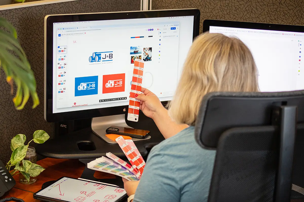 What Size Should a Logo Be? - myheartcreative A designer looking at a color swatch