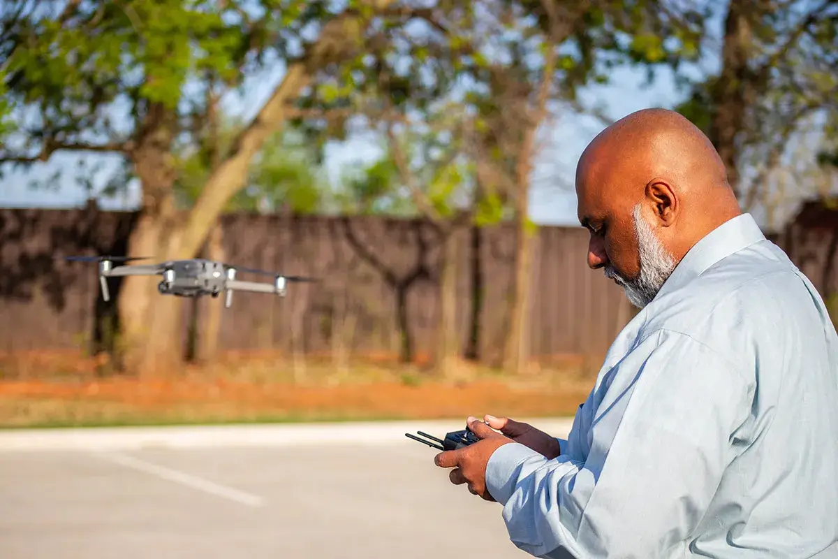A drone operator flying a drone