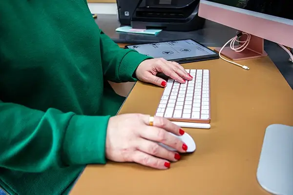 Typing on keyboard in front of monitor