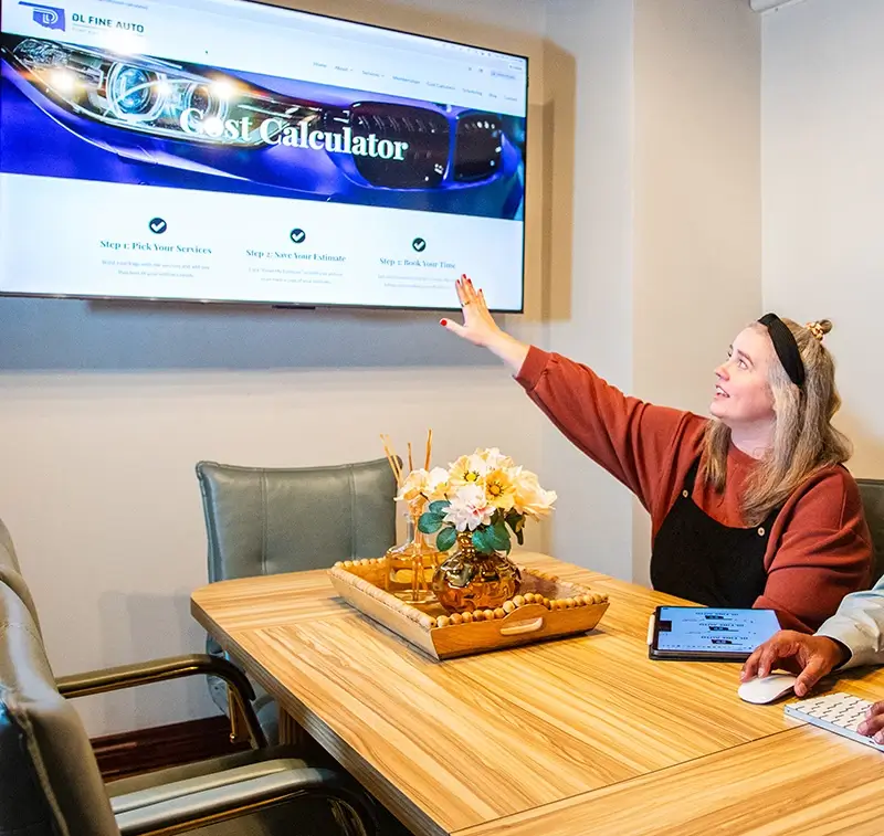 Creative Director Amy discussing client website pulled up on monitor