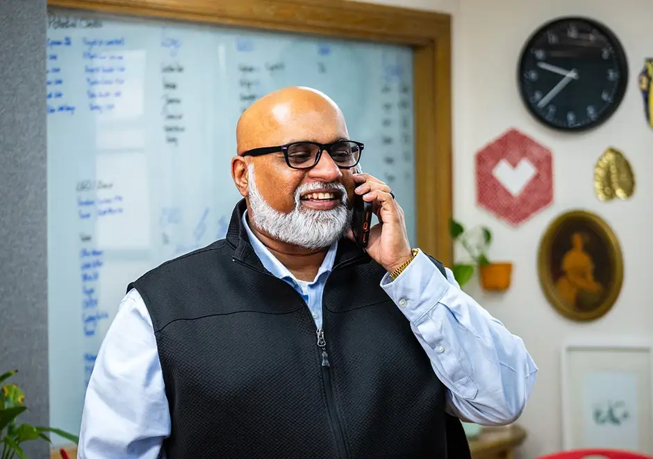 Sam on the phone with a client
