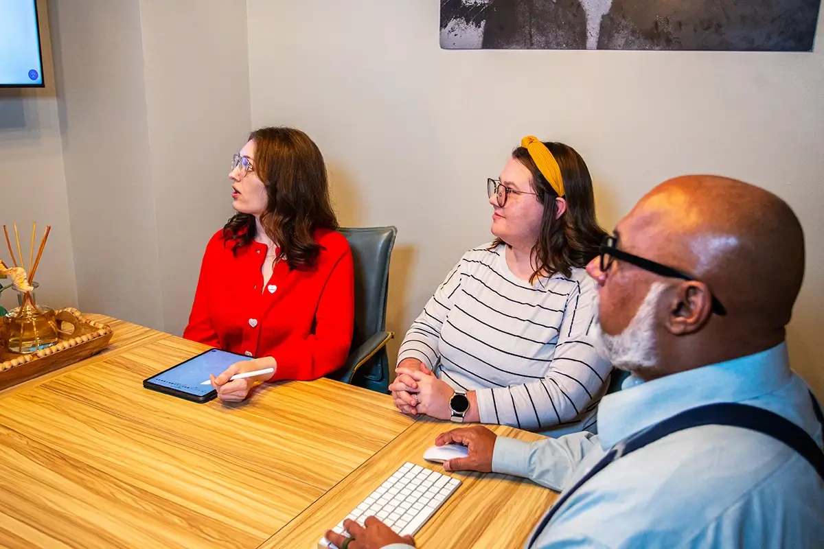 Three digital marketers meeting in a conference room