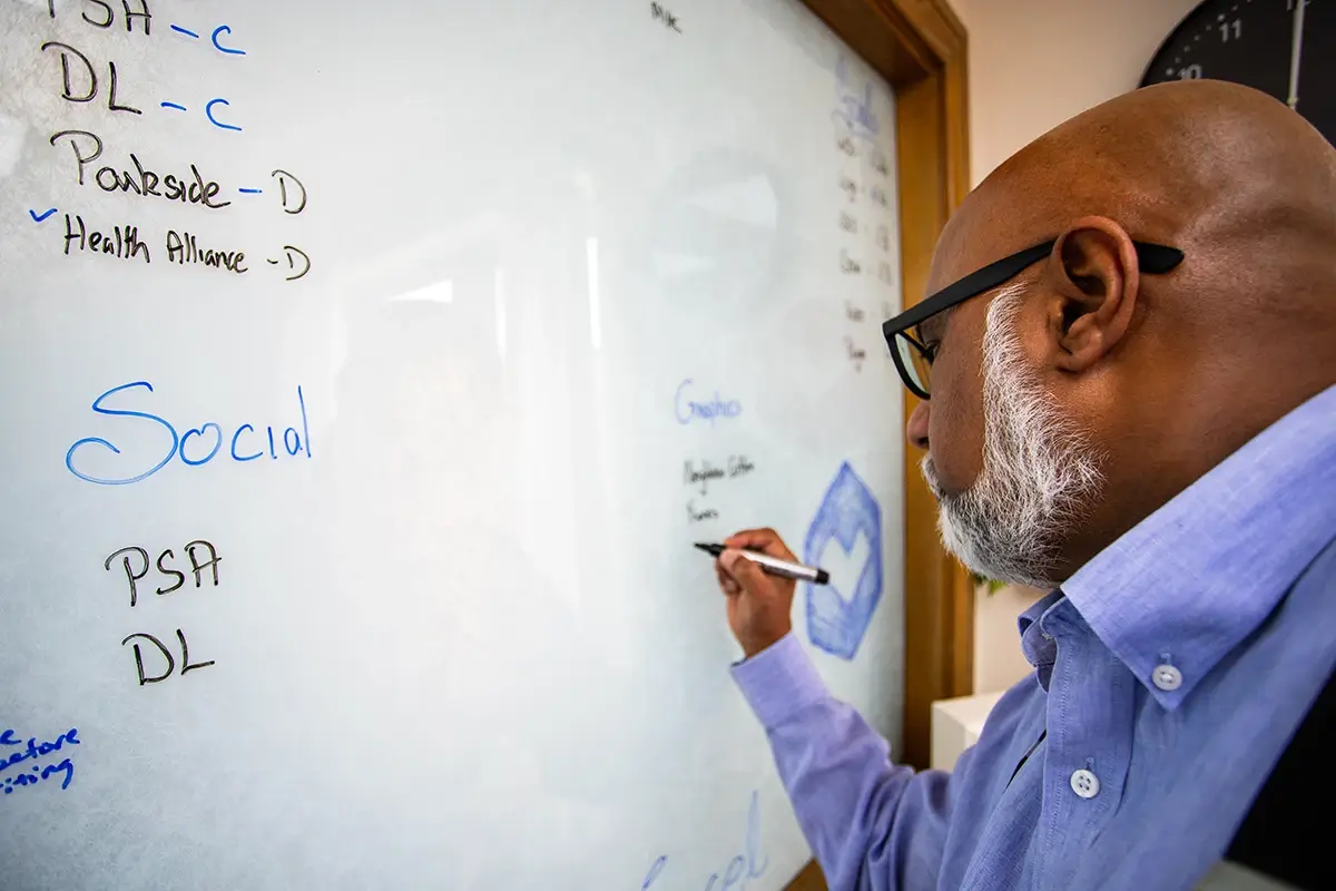 A digital marketer writing on a white board