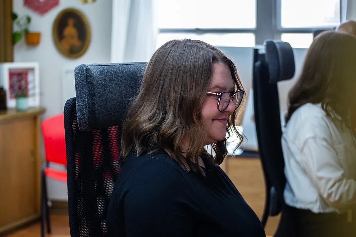 How to Set Up a Business Facebook Page - myheartcreative A person sitting in a black ergonomic office chair with a textured grey headrest.