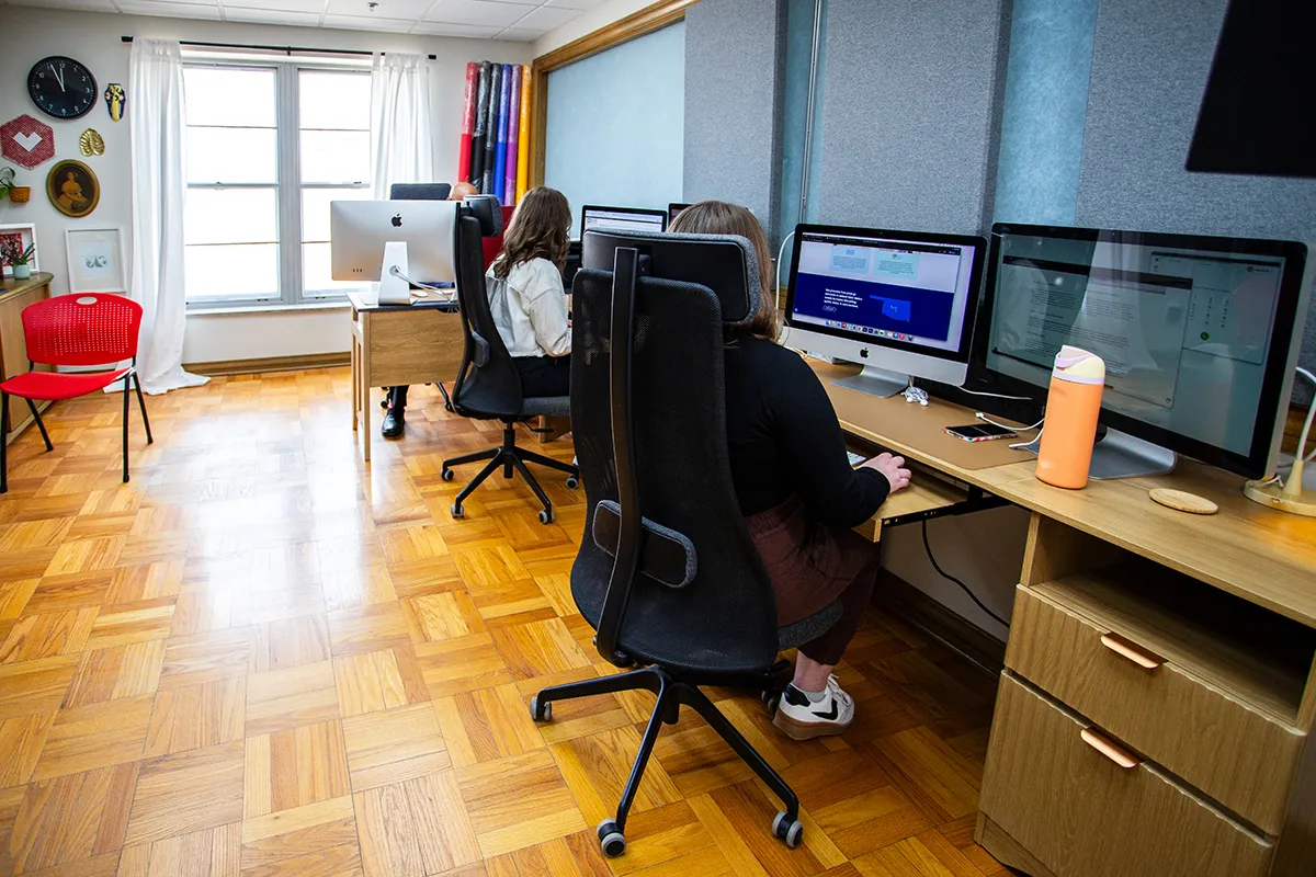 SEO for Beginners - myheartcreative This office features a sleek, ergonomic black office chair positioned at a wooden desk with a dual-monitor computer setup