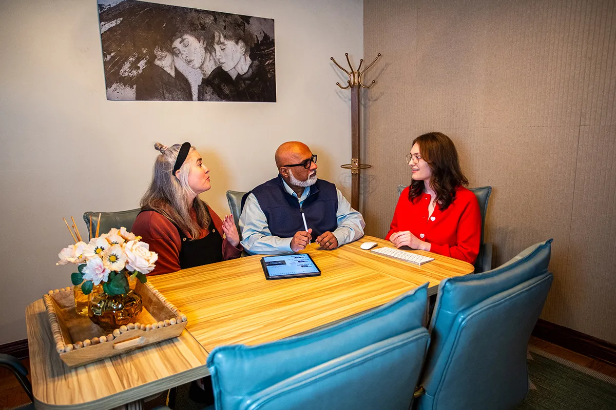 Creative design studio team conducting a client consultation in an office conference room.