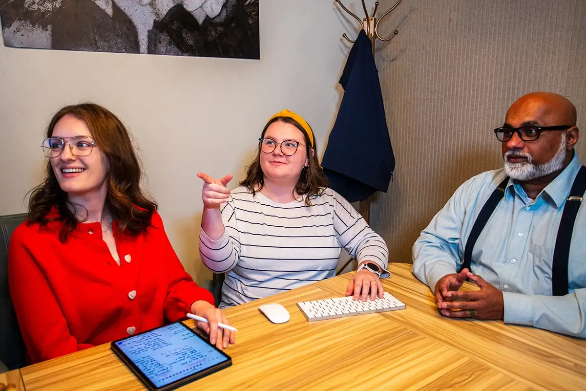 Digital Accessibility Requirements: What to Know in 2026 - myheartcreative Kristen, Caitlin, and Sam looking at a monitor during a meeting